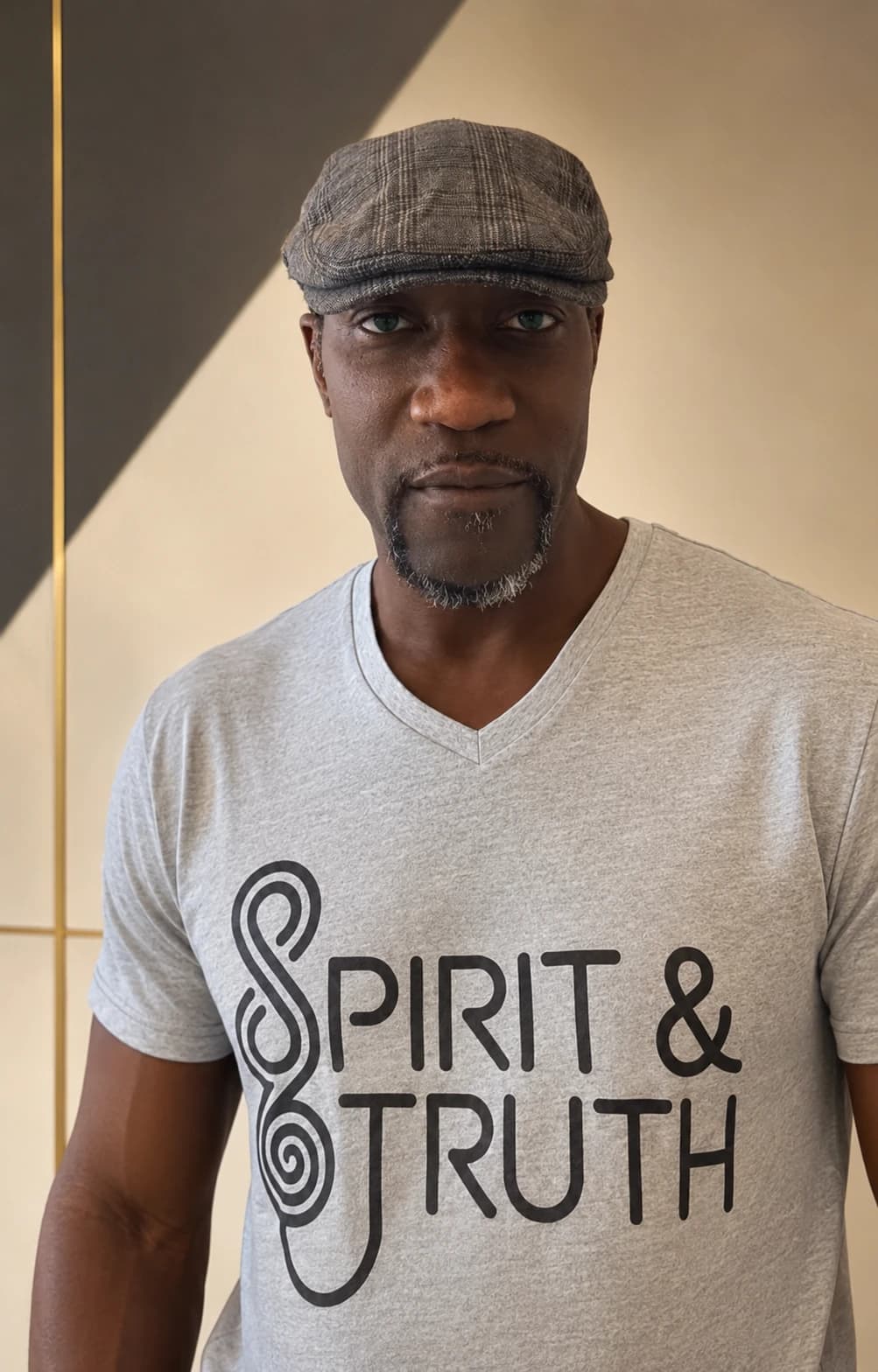 AI-assisted editorial image of Michael E. Martin Jr. wearing a heather-gray Spirit and Truth shirt